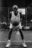 Legacy on asphalt, powered by AI Black and white AI-generated portrait of an older basketball player gripping a ball on a dimly lit street court, wearing Nike gear — full of presence, grit, and determination