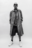 Confident AI-generated portrait of a model in oversized Bareen coat, striped shirt, and chunky sneakers, standing against a plain white backdrop